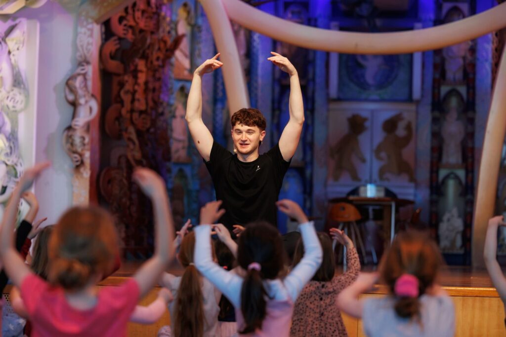 A Dance Educator from RBNZ working with a group of children and having fun